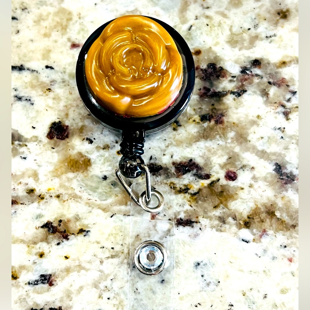 Brown flower and diamond badge reel.